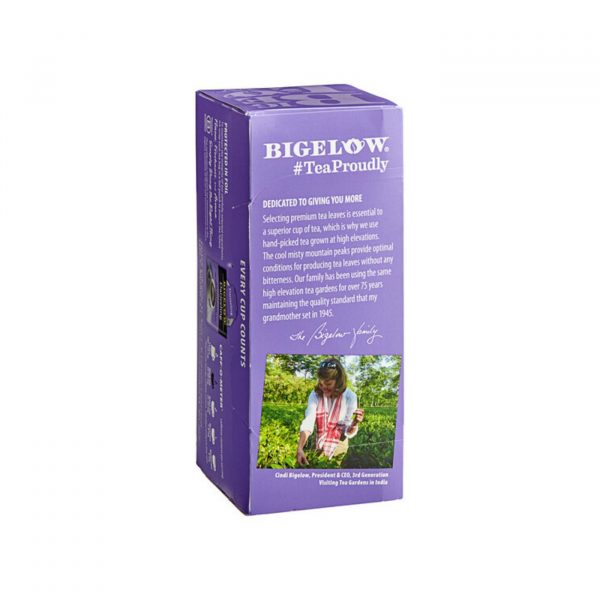 Side view of a Bigelow Darjeeling Tea box featuring brand information, tea description, and an image of a tea garden worker on purple packaging.