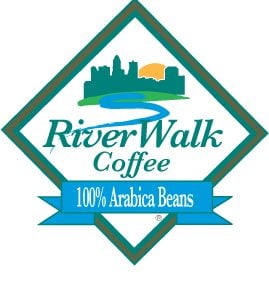 Riverwalk Coffee logo featuring a city skyline, a rising sun, and a winding river. The design includes a blue ribbon stating “100% Arabica Beans” beneath the brand name.