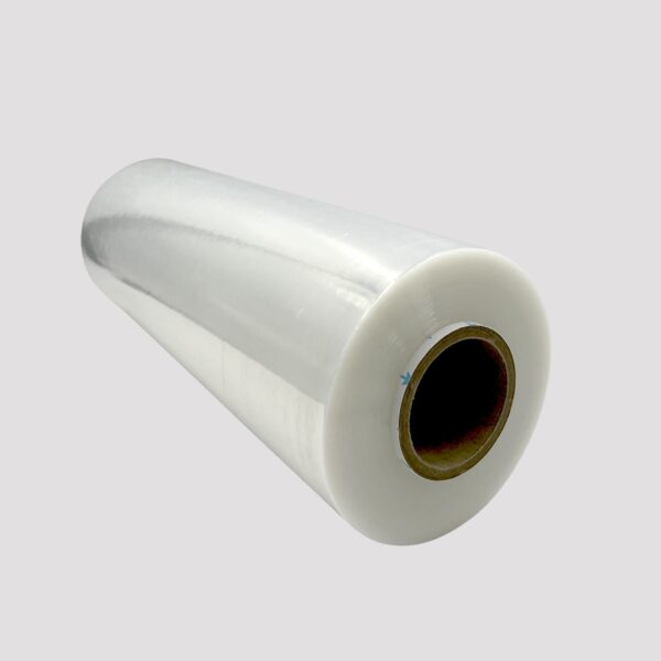Roll of clear hand stretch wrap film with cardboard core, shown against a light gray background. Used for securing pallets and packaging in shipping or warehouse settings.