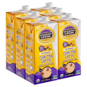 Six 32 oz cartons of Oregon Chai Tea Latte Concentrate, labeled organic and gluten-free, featuring purple and yellow packaging with preparation instructions.