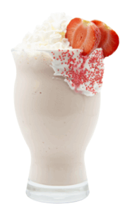 Strawberry marshmallow milkshake in a curvy glass, topped with whipped cream, halved strawberries, and pink sprinkles over a swirl of marshmallow cream on the rim.