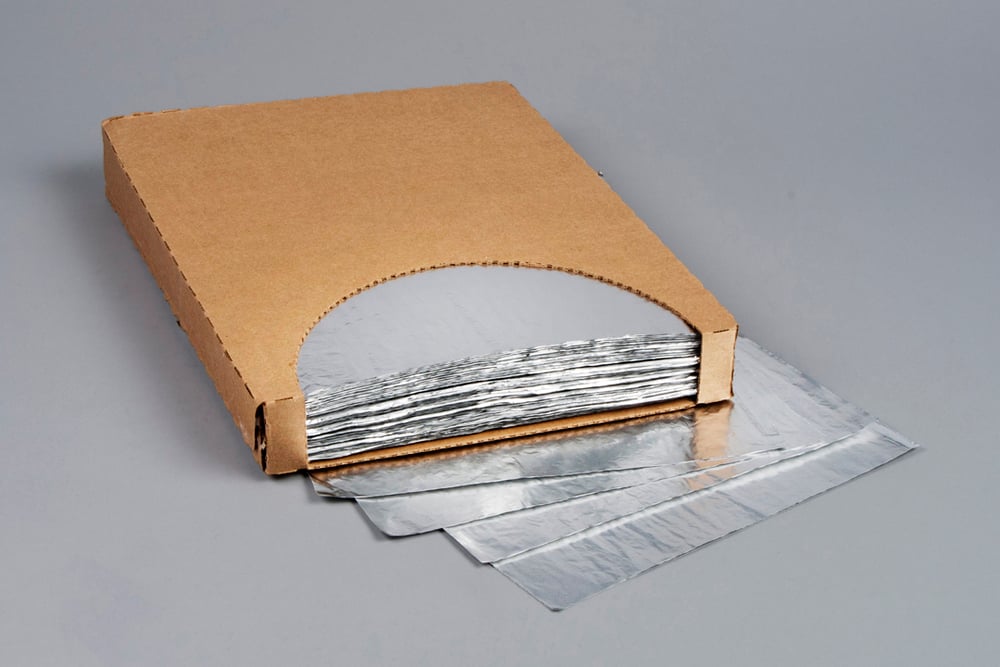 A stack of 14" x 16" insulated cushion foil wraps partially pulled out from a brown cardboard dispensing box on a gray surface.