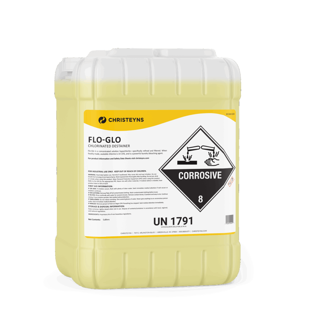 A 5-gallon yellow chlorinated destainer container labeled “Christeyns Flo-Glo” with a large corrosive hazard symbol and product information printed on the front.